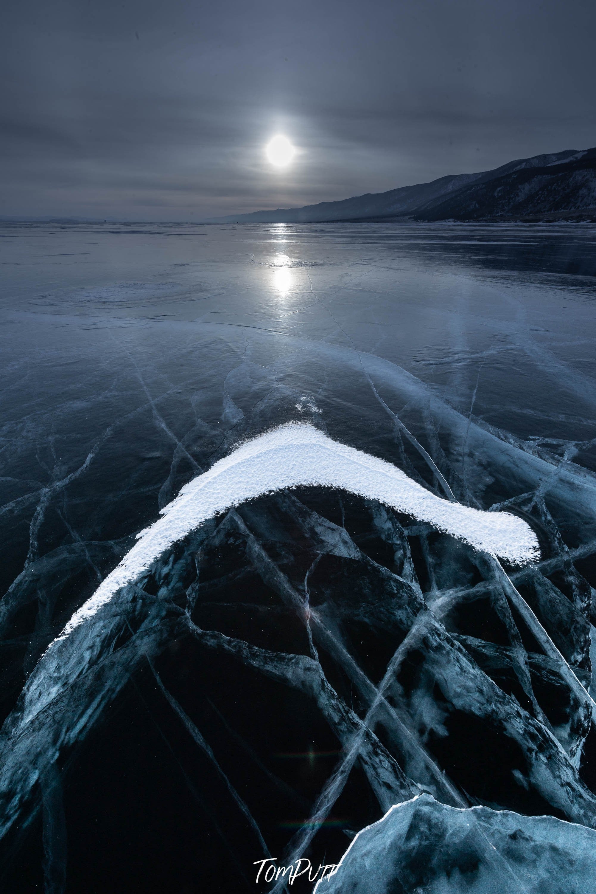 A frozen lake with some fresh snow, and a moonlight effect in the background, Lake Baikal #31, Siberia, Russia