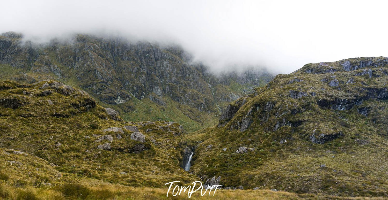 A greenfield area with two big grass mounds, Lake Harris, Routeburn Track - New Zealand