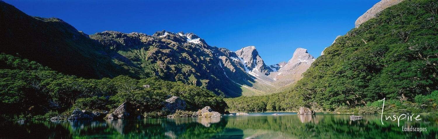 Small lake surrounded by giant green mountains, Lake MacKenzie, Routeburn Track - New Zealand 