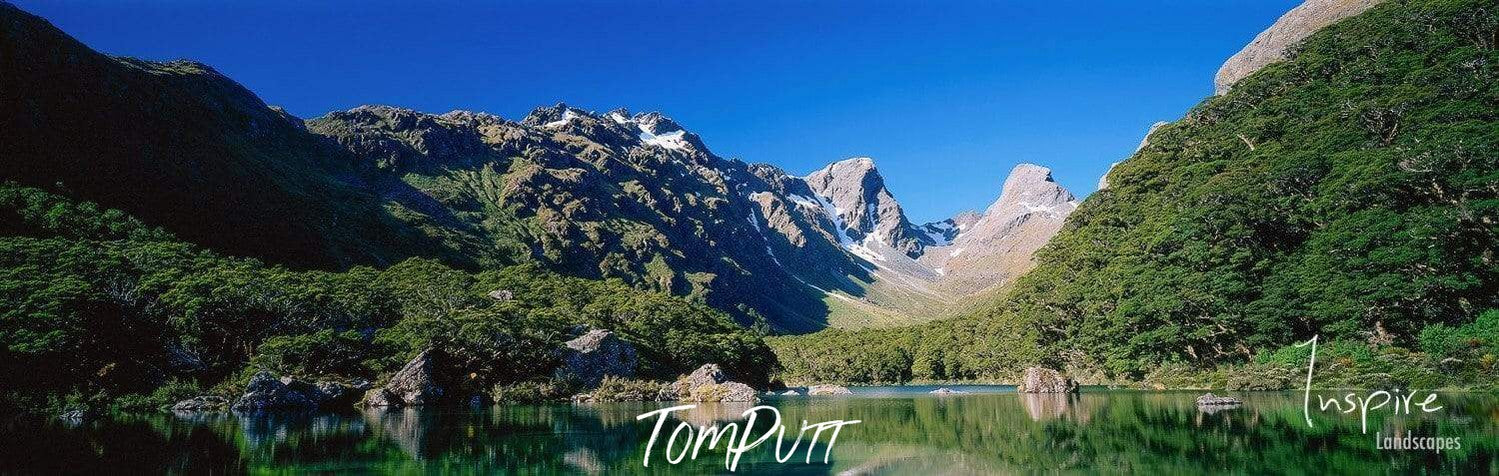 Small lake surrounded by giant green mountains, Lake MacKenzie, Routeburn Track - New Zealand 