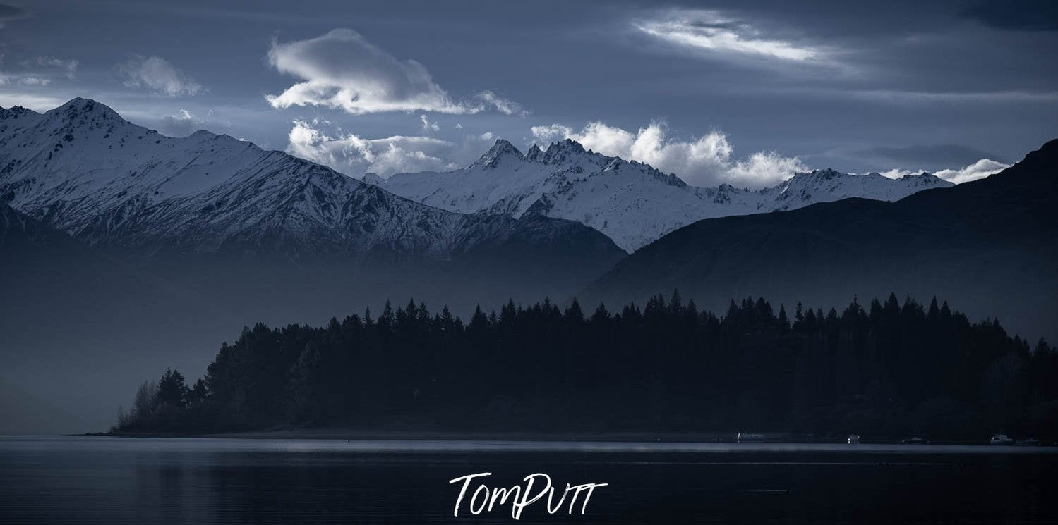 Dark view of long mountain walls some with greenery below and smoky clouds over, New Zealand #15