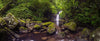 Long sequence of small greeny stones, and a small waterfall into a lake in the background, Lamington Waterfall Panoramic QLD