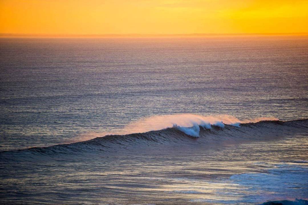 A large view of a wave in a sea with a sunset effect besides, Last Wave, Portsea 
