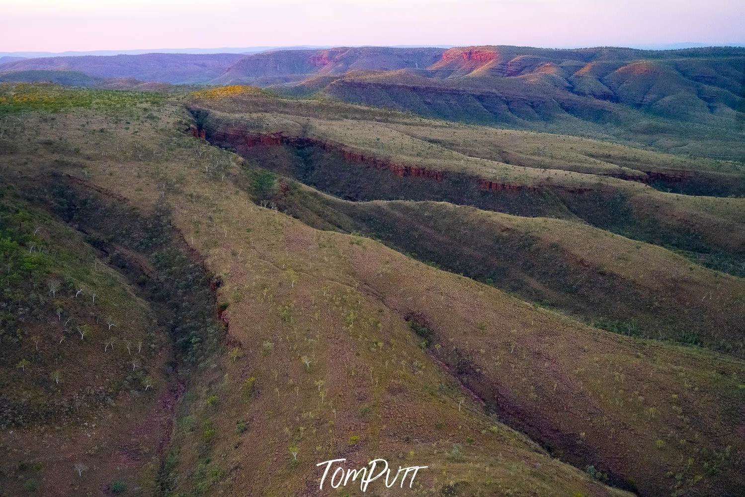 A large mountainy land area with huge cracks and a dim light effect, Late Light, Carr Boyd Ranges, The Kimberley