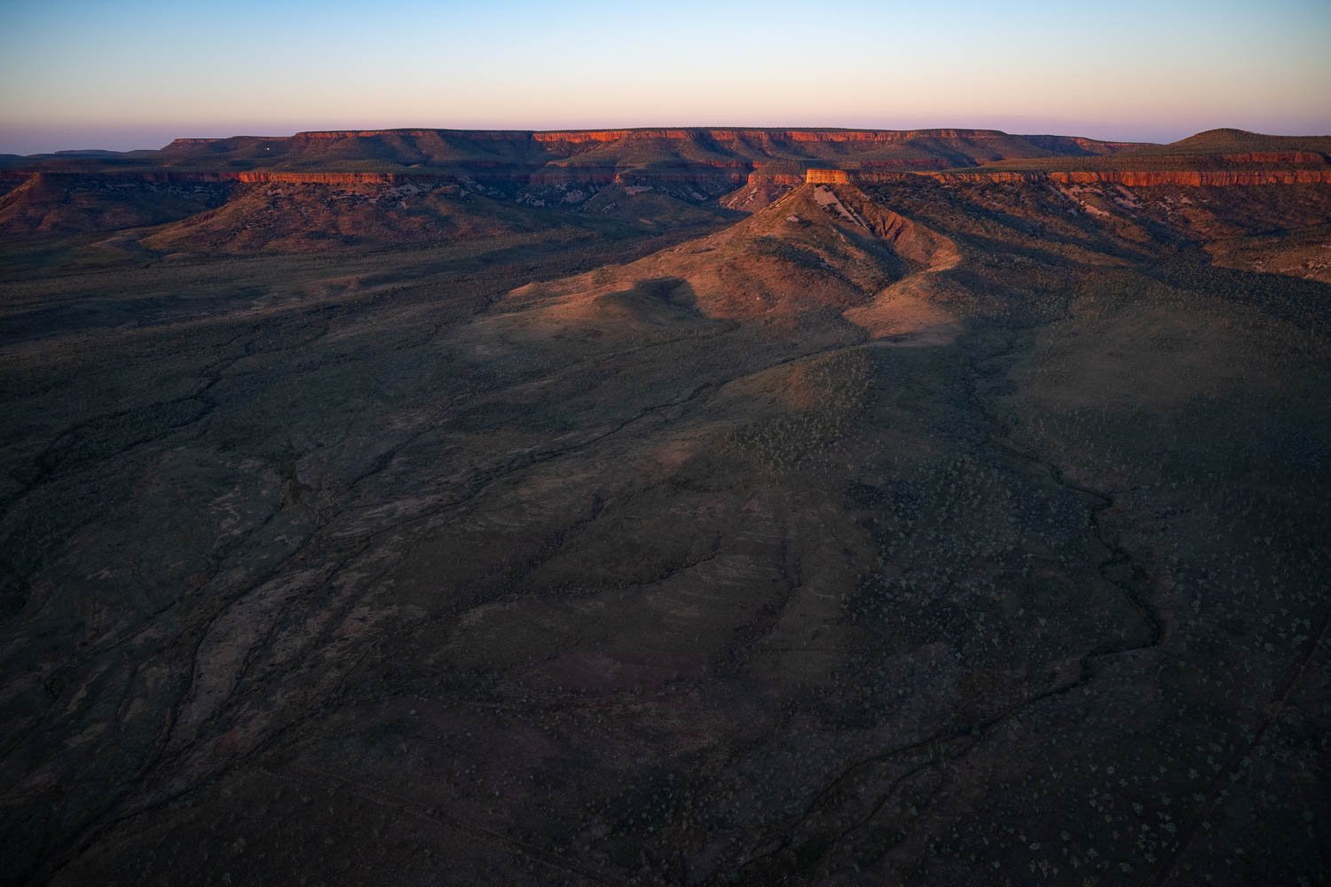A large mountainy land area with some mounds and a partially hitting sunlight, Late Light, Carr Boyd Ranges, The Kimberley
