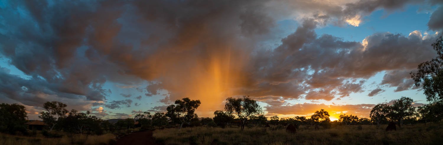 Dark greenery area covered with thick golden showering clouds, Late Shower - Karijini, The Pilbara