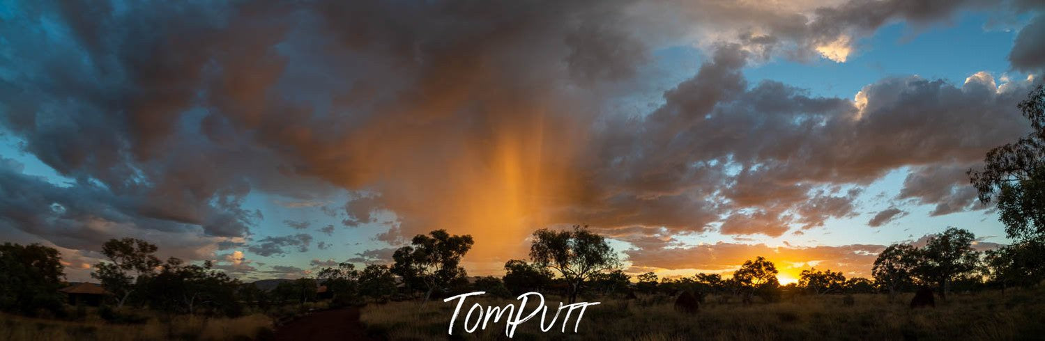 Dark greenery area covered with thick golden showering clouds, Late Shower - Karijini, The Pilbara