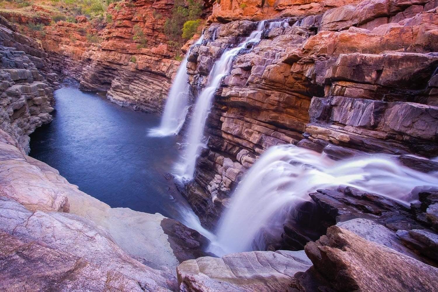 Multiple waterfalls from mountain walls in a small water course below, Lennard Falls - The Kimberley WA