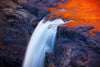 Waterfall from a miuntains edge with a lava coming to fall together, Liquid Gold, Mitchell Falls - The Kimberley WA
