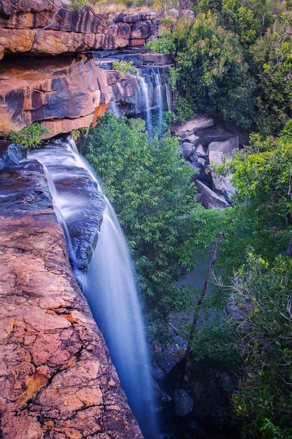 High rocks with a waterfall and a lot of plants and trees around, Little Mertens - The Kimberley WA