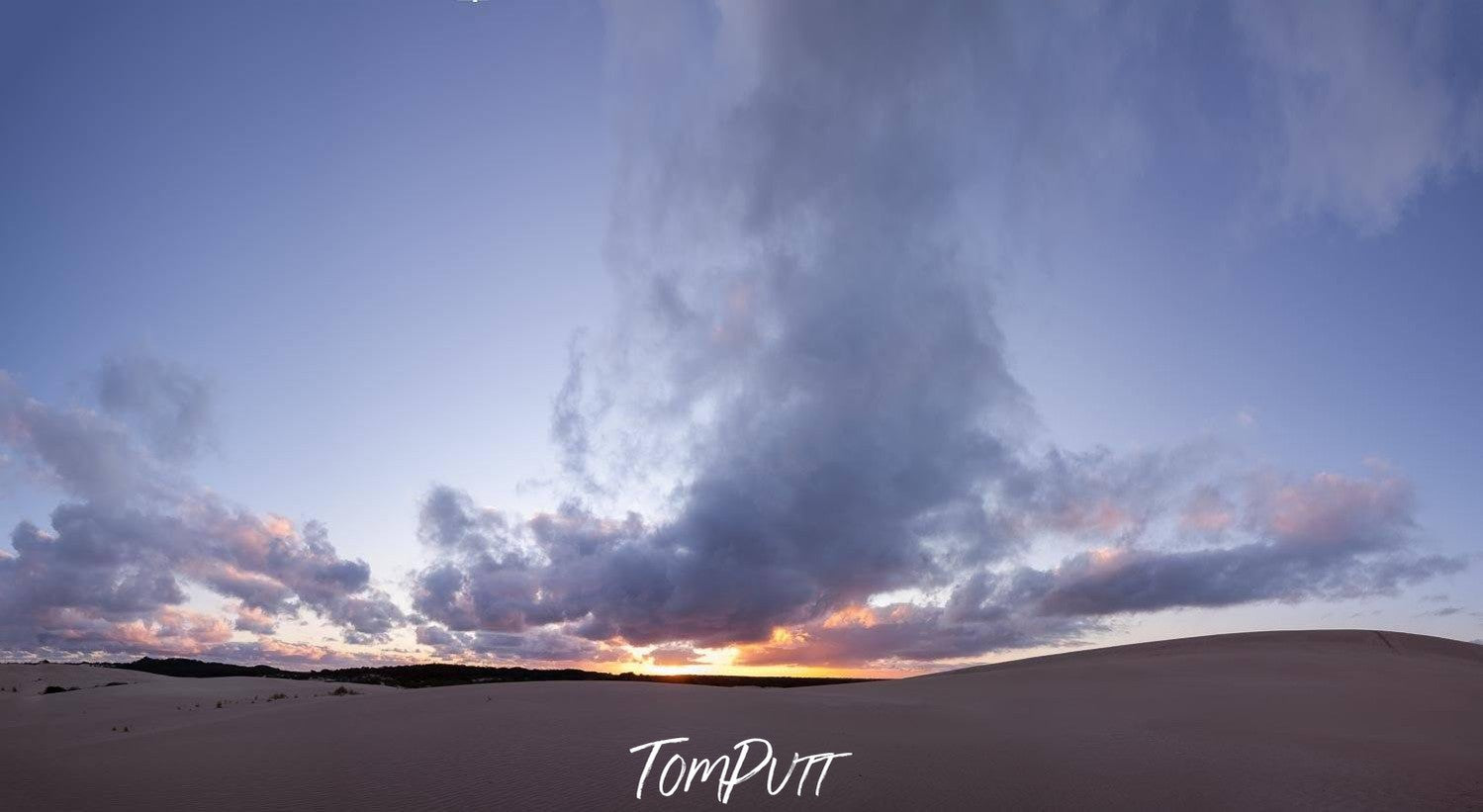 A desert with giant smoky clouds over, and a view of sunset in the far background, Little Sahara Dusk - Kangaroo Island SA