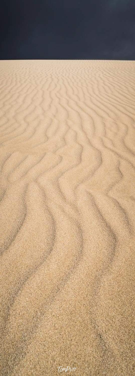 Portrait view of Sahara desert with some wavy lines and a dark black background, Little Sahara - Kangaroo Island SA