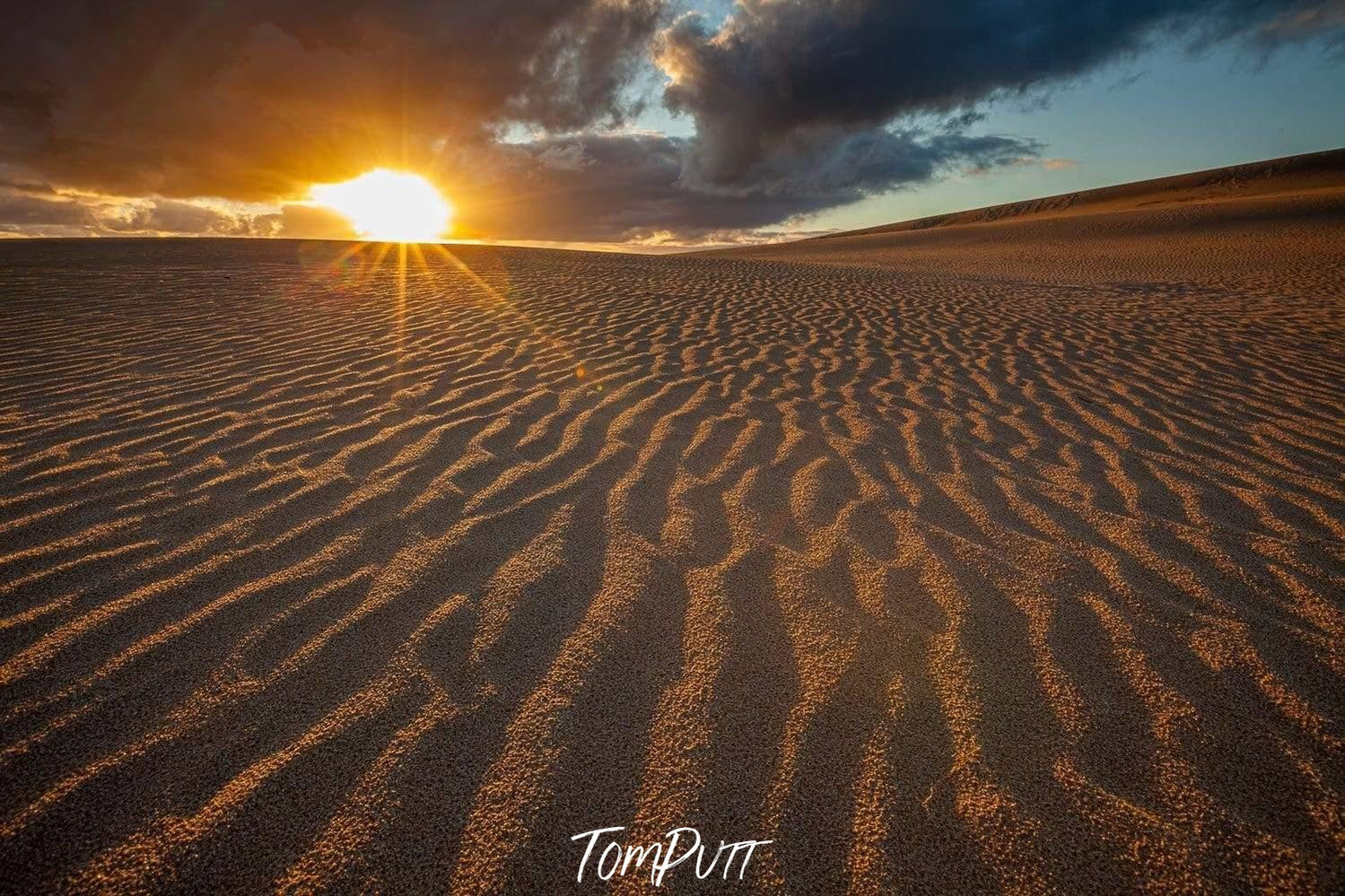 A desert with giant black clouds over with lite sunlight rays, Little Sahara Sunset - Kangaroo Island SA