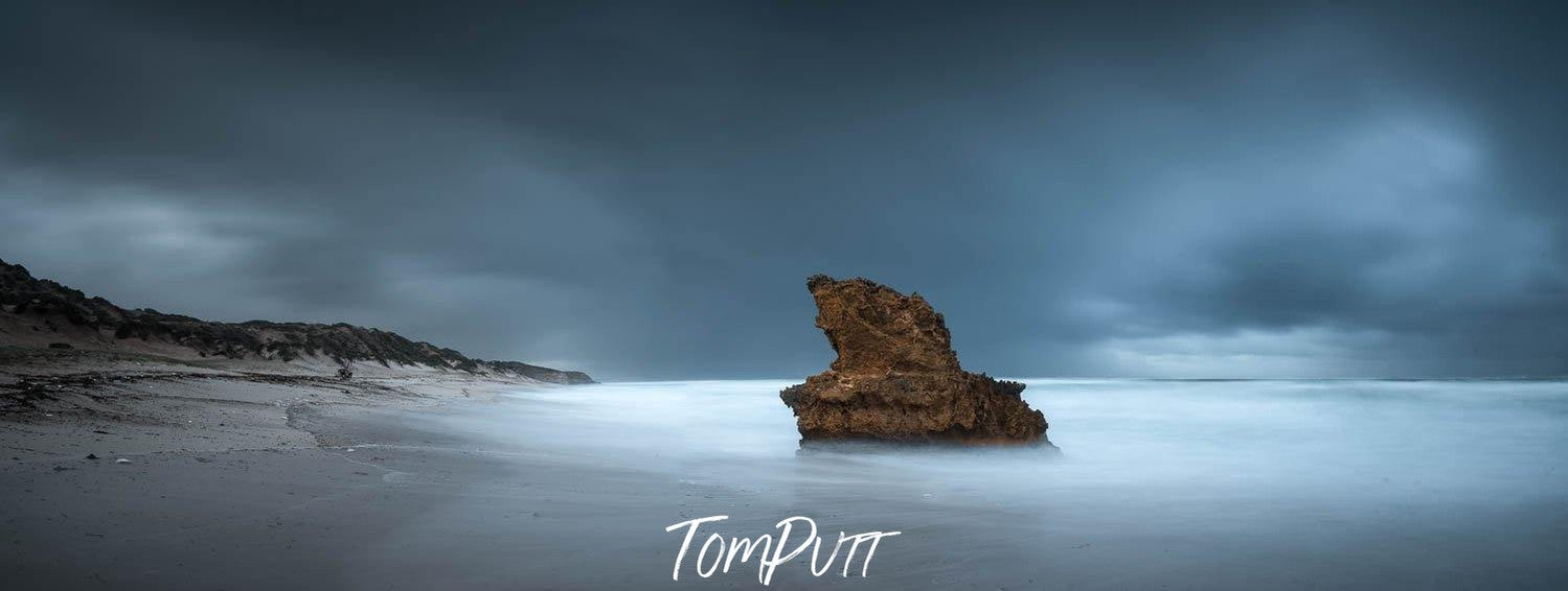 Large mountain standing in the middle of a sea with thick black clouds over, Lizard Rock Storm - Mornington Peninsula VIC