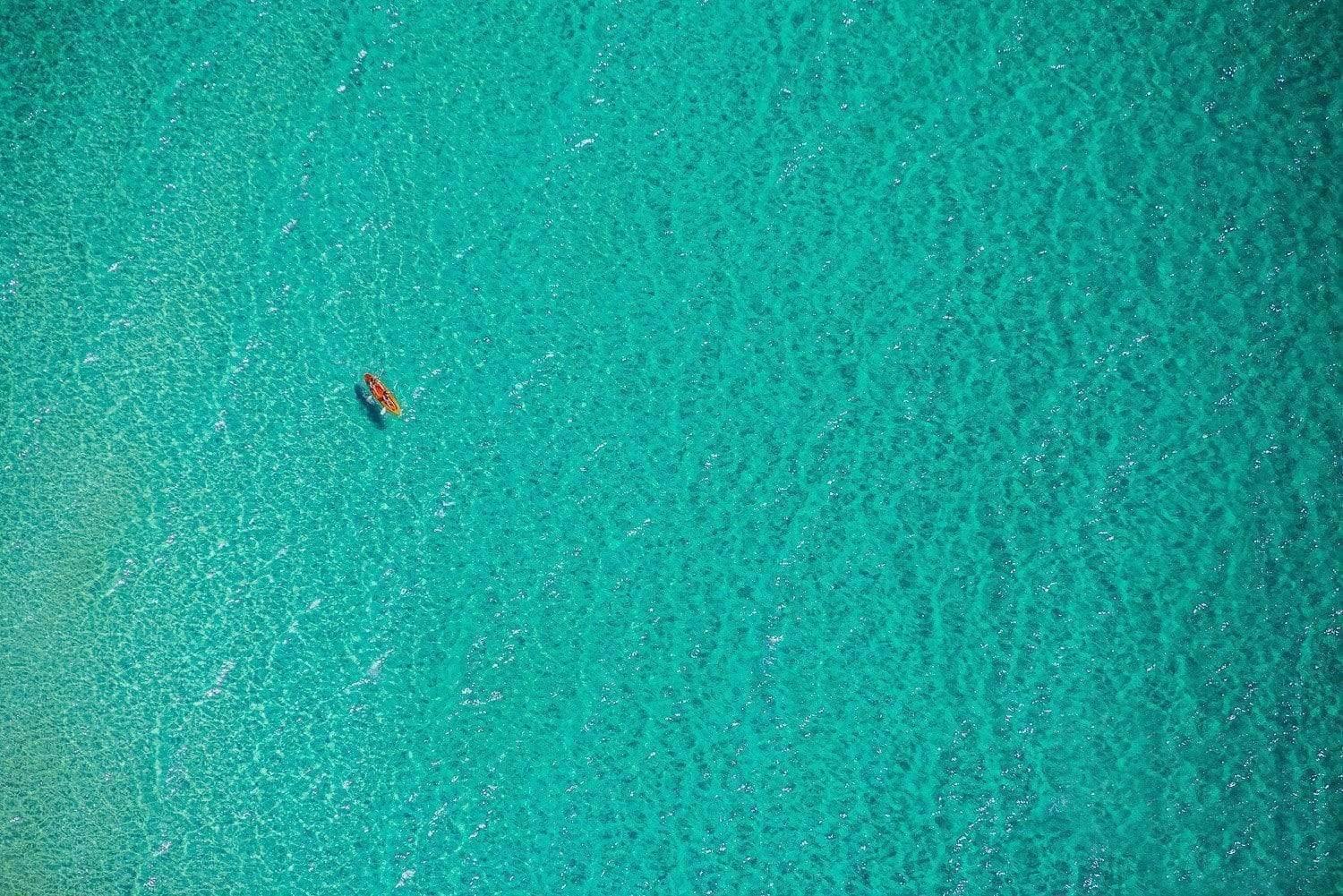 Aerial view of a green water sea with a floating boat, Lone Paddlers Mornington Peninsula Art