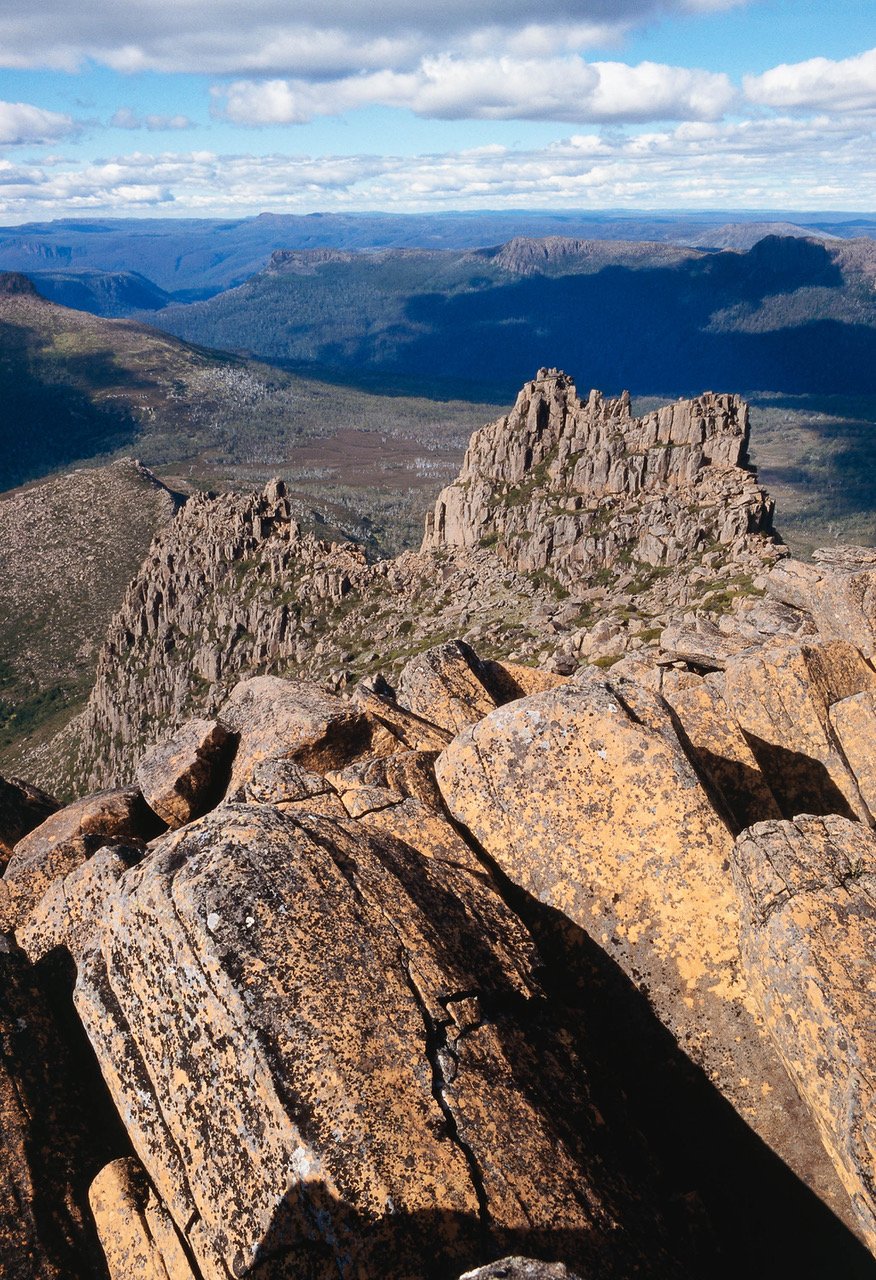 A hill point with some large stones and a long hill area in the background, Cradle Mountain #33, Tasmania