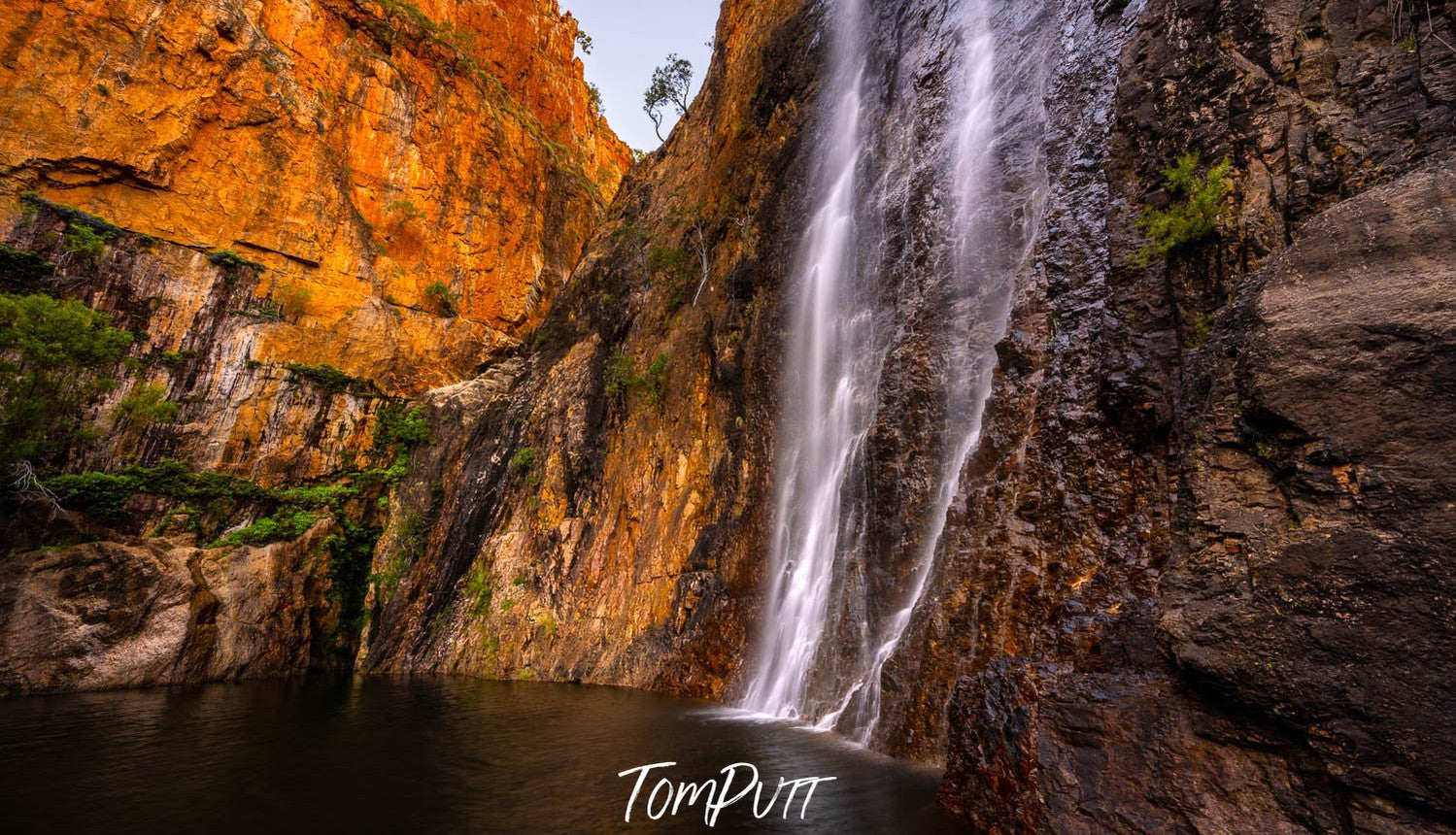 Giant mountain walls with a waterfall in a lake below, Miri Miri Falls, El Questro, The Kimberley, Western Australia