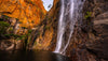 Giant mountain walls with a waterfall in a lake below, Miri Miri Falls, El Questro, The Kimberley, Western Australia