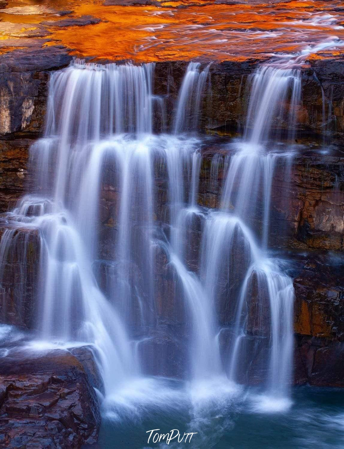 Wide waterfalls from a mountain wall into a lake, Mitchell Falls Cascades, The Kimberley, Western Australia