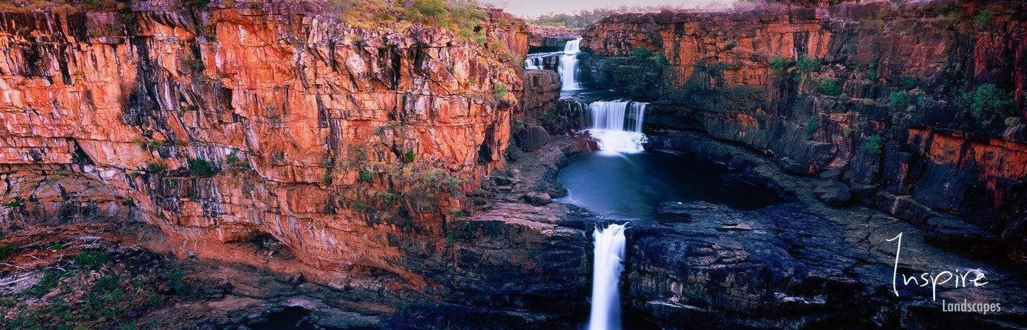 A long shot of nested waterfalls from a mountain wall and a lake, Mitchell Falls panorama, The Kimberley, Western Australia