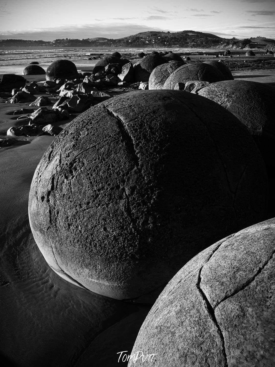 Dark view of giant boulder on a seashore-like land, Moeraki Eggs New Zealand Art