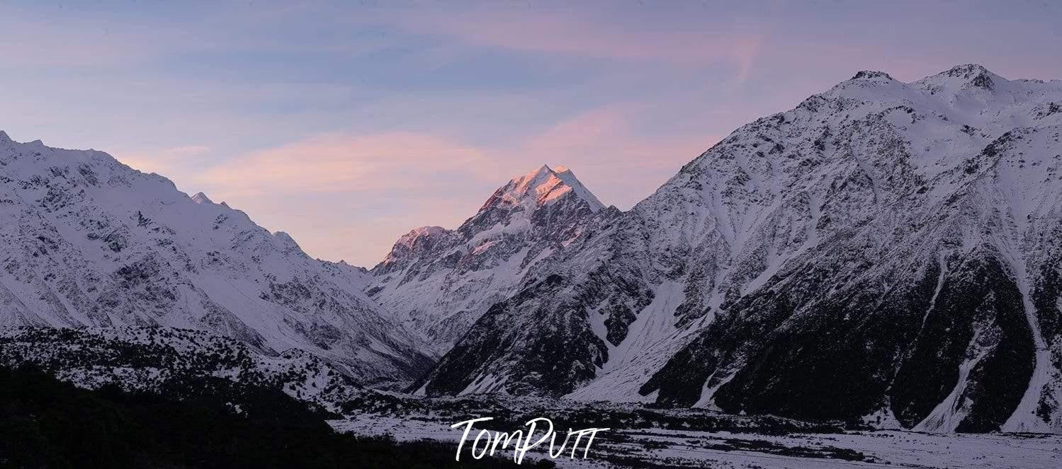 A dim light view of giant mountains covered with snow, Mount Cook Sunset - New Zealand