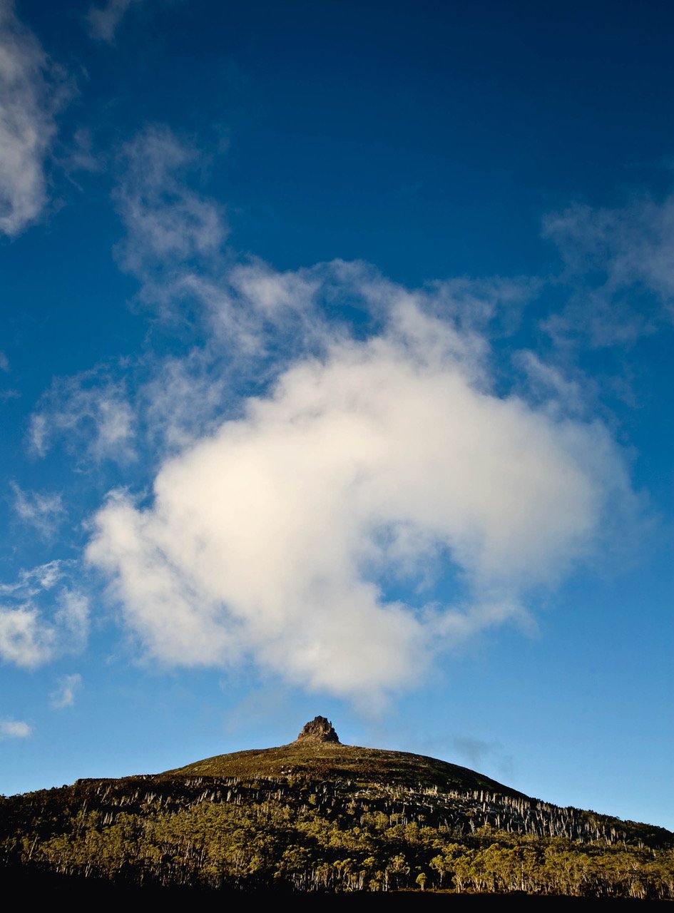 A mountain peak point with rounded white clouds over it, Cradle Mountain #8, Tasmania 