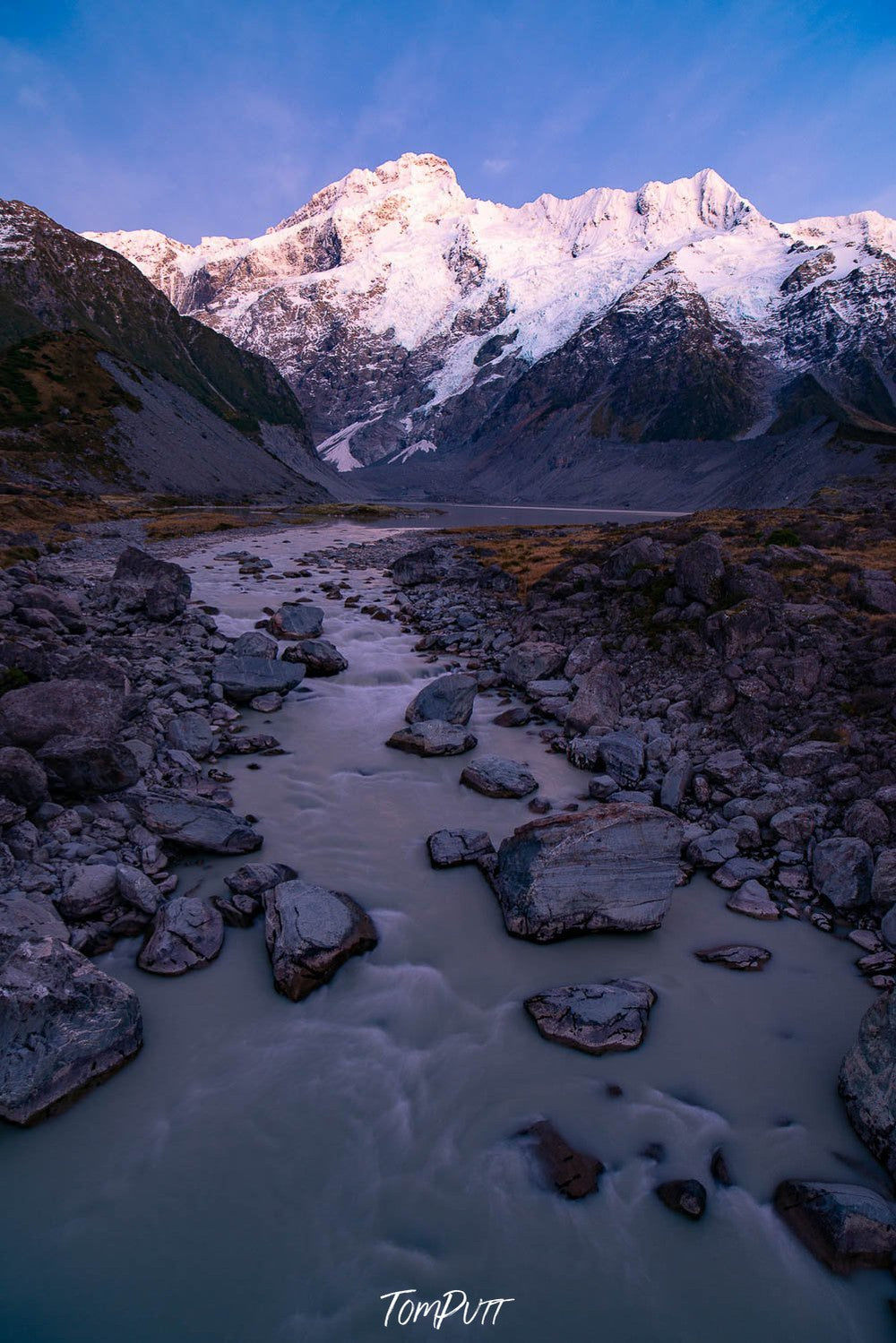 A pathway between mountains with many stones on the ground, New Zealand #1