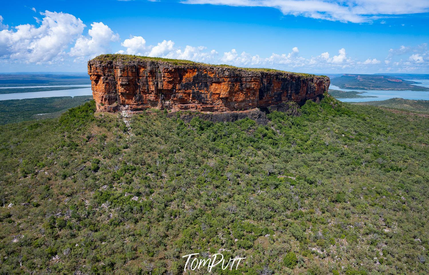 A long mountain wall in the middle of a long green area, Mount Trafalgar, The Kimberley, Western Australia