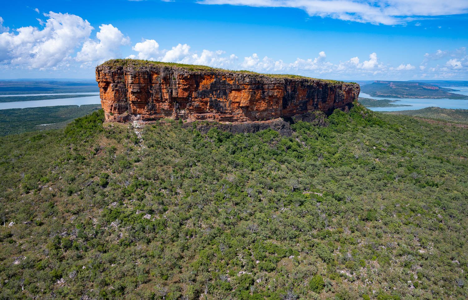 A long mountain wall in the middle of a long green area, Mount Trafalgar, The Kimberley, Western Australia
