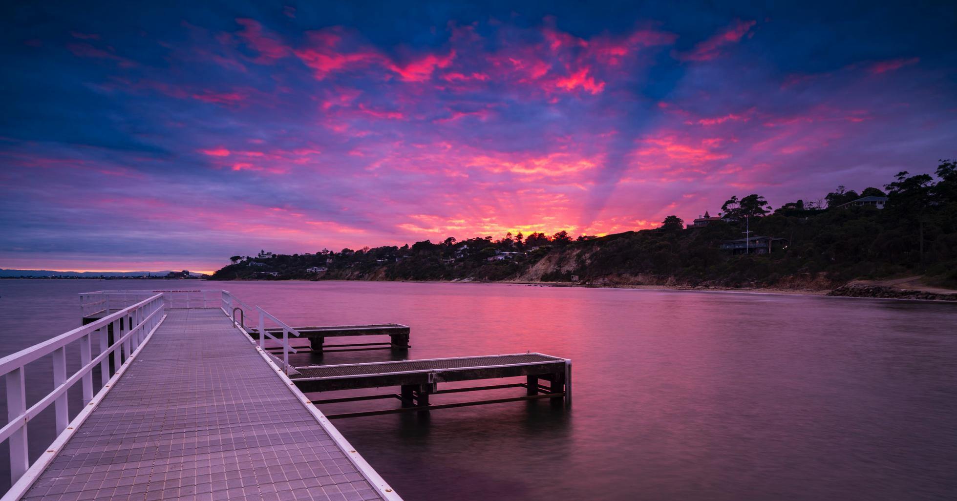 A wooden bridge over water a lake, and a pinkish weather effect, Mt Eliza Sunrise - Mornington Peninsula VIC