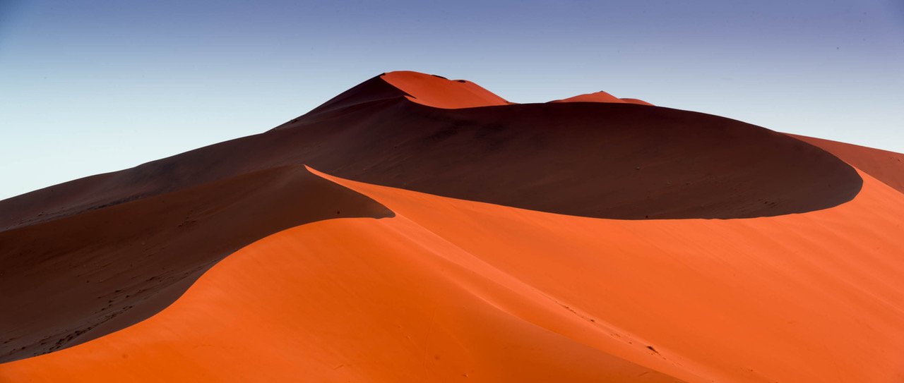 A mound of sand in a desert with partially hitting sunlight, Namibia #10, Africa