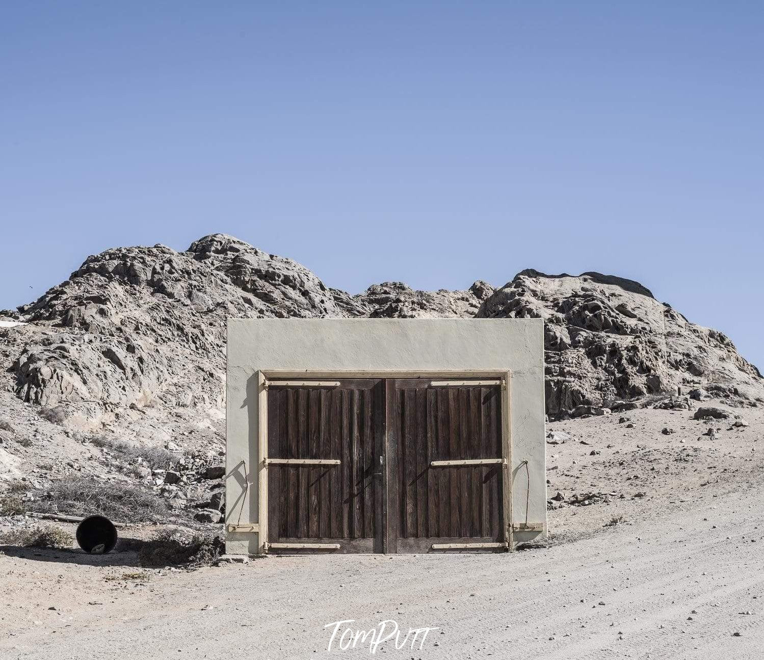 A cell between a desert, with two mounds in the background, Namibia No.13 Artwork