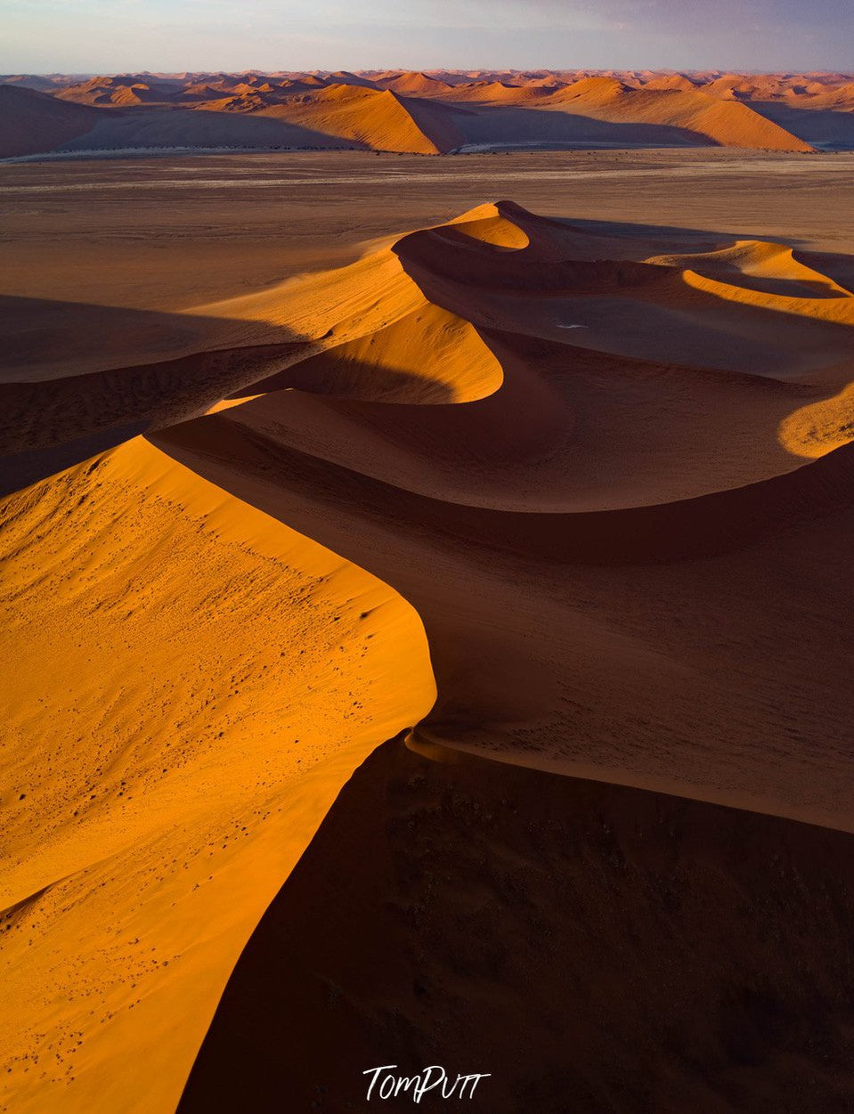 Aerial view of a wavy desert, with partially hitting sunlight, Namibia #5, Africa