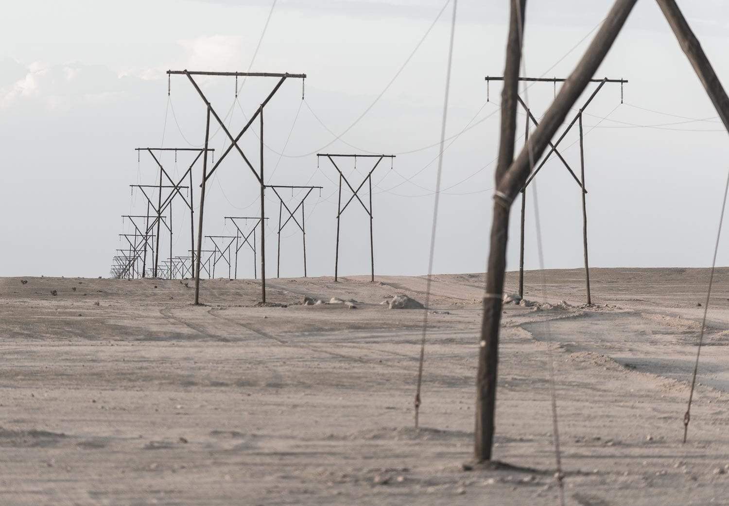 Long series of electricity towers with some wires connected, Namibia #9