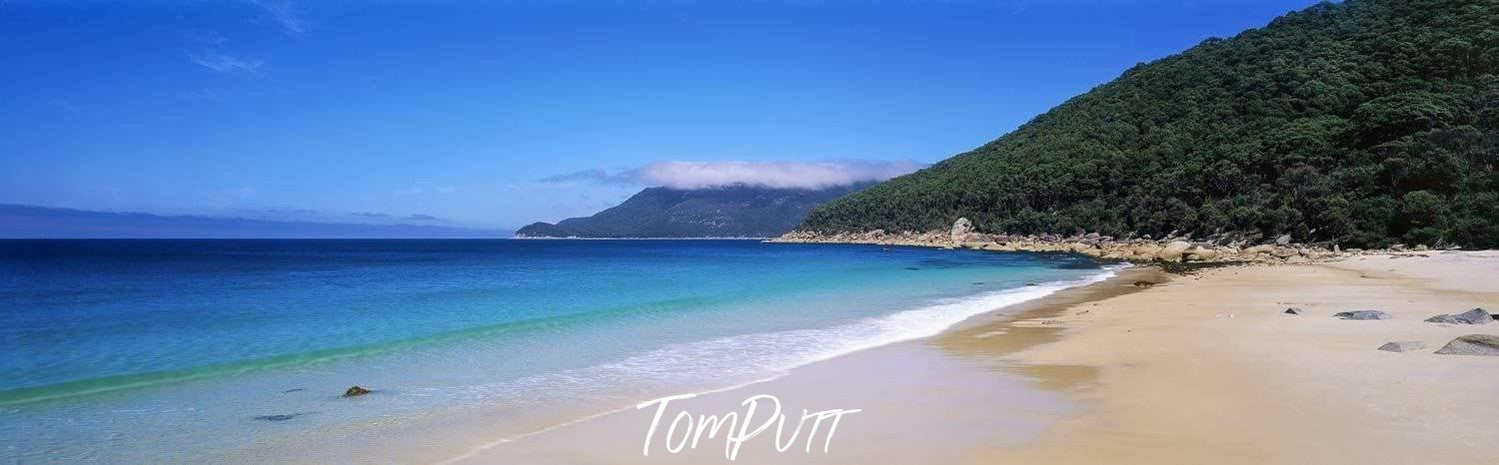 Ice-blue beach with a long mountain wall covered with thick plants and bushes, North Waterloo Bay - Wilson's Promontory VIC