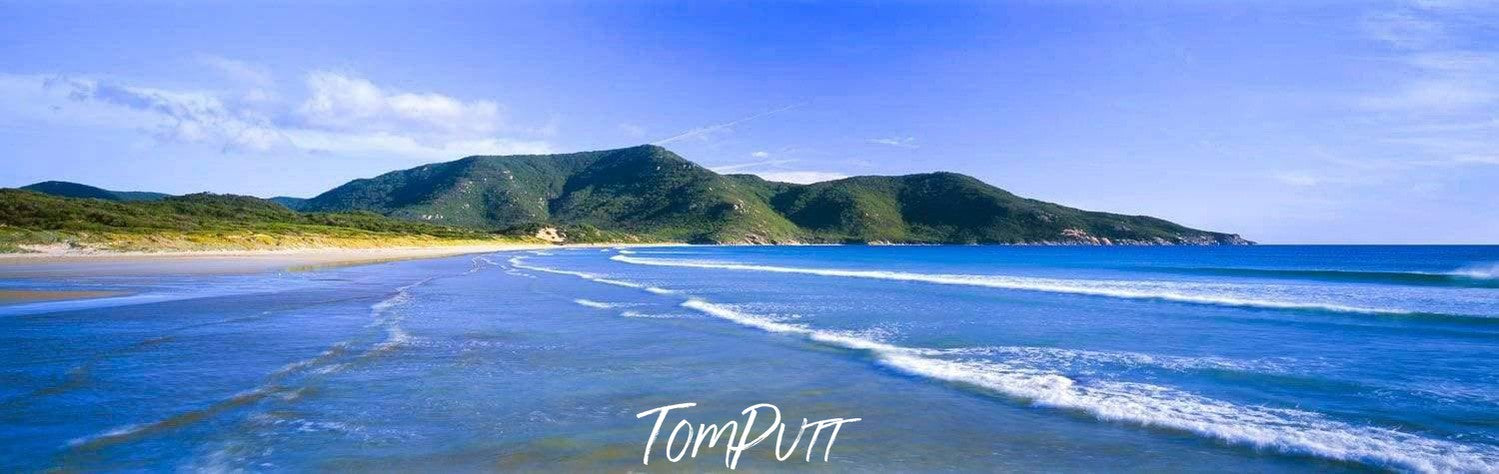 Small sea waves with a dark green mountain beside the sea, Oberon Bay - Wilson's Promontory VIC