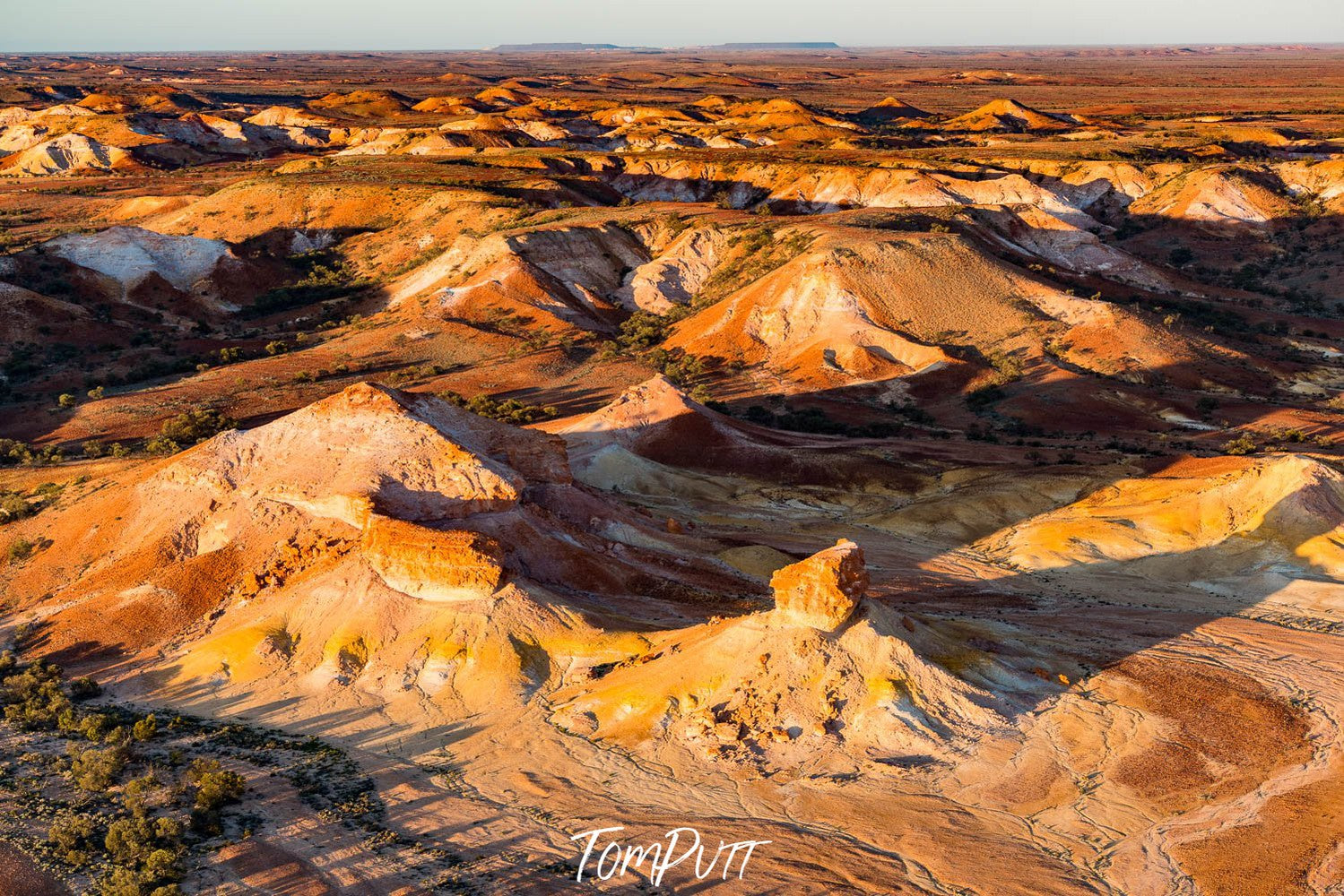 Aerial view of large golden mountains on desert land with sunlight fall, Painted Hills #15