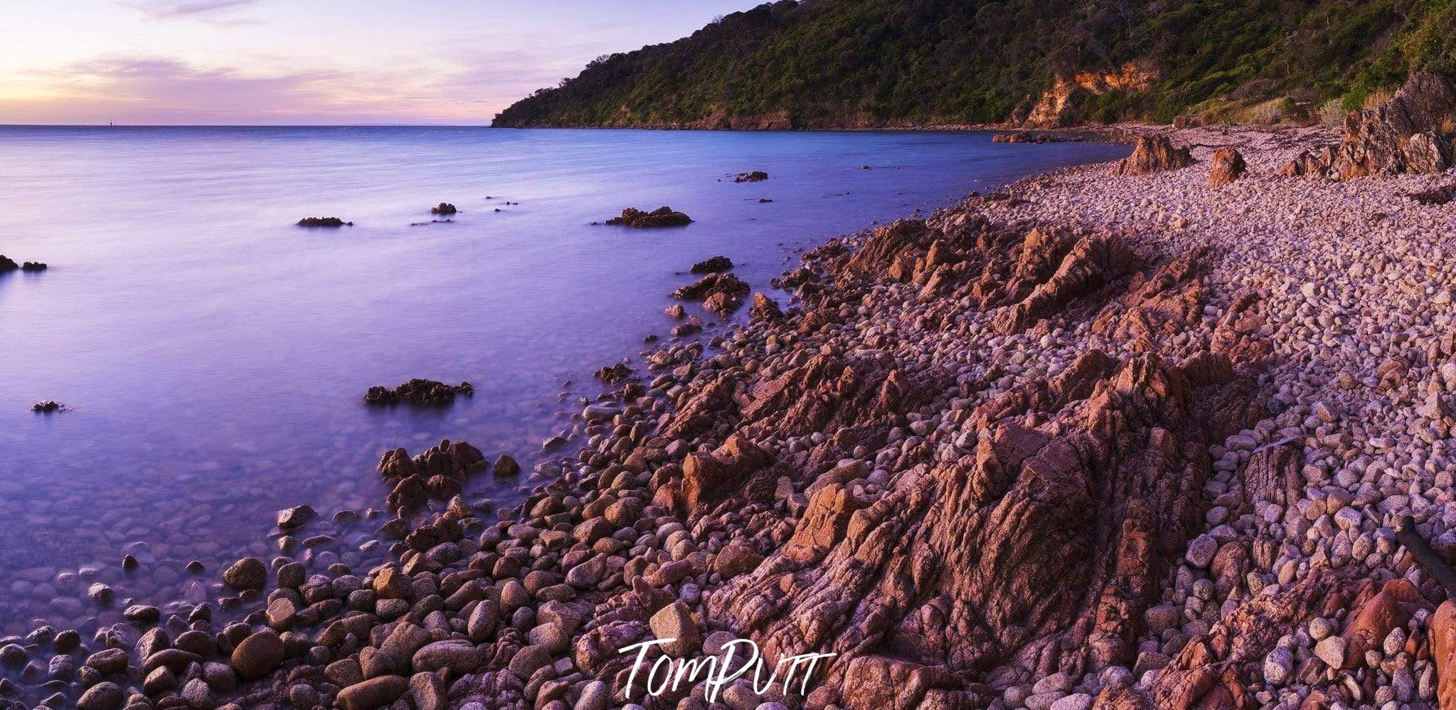 A lake having a stony beach and a long mountain wall beside, Pebble Beach, Mt Martha - Mornington Peninsula VIC