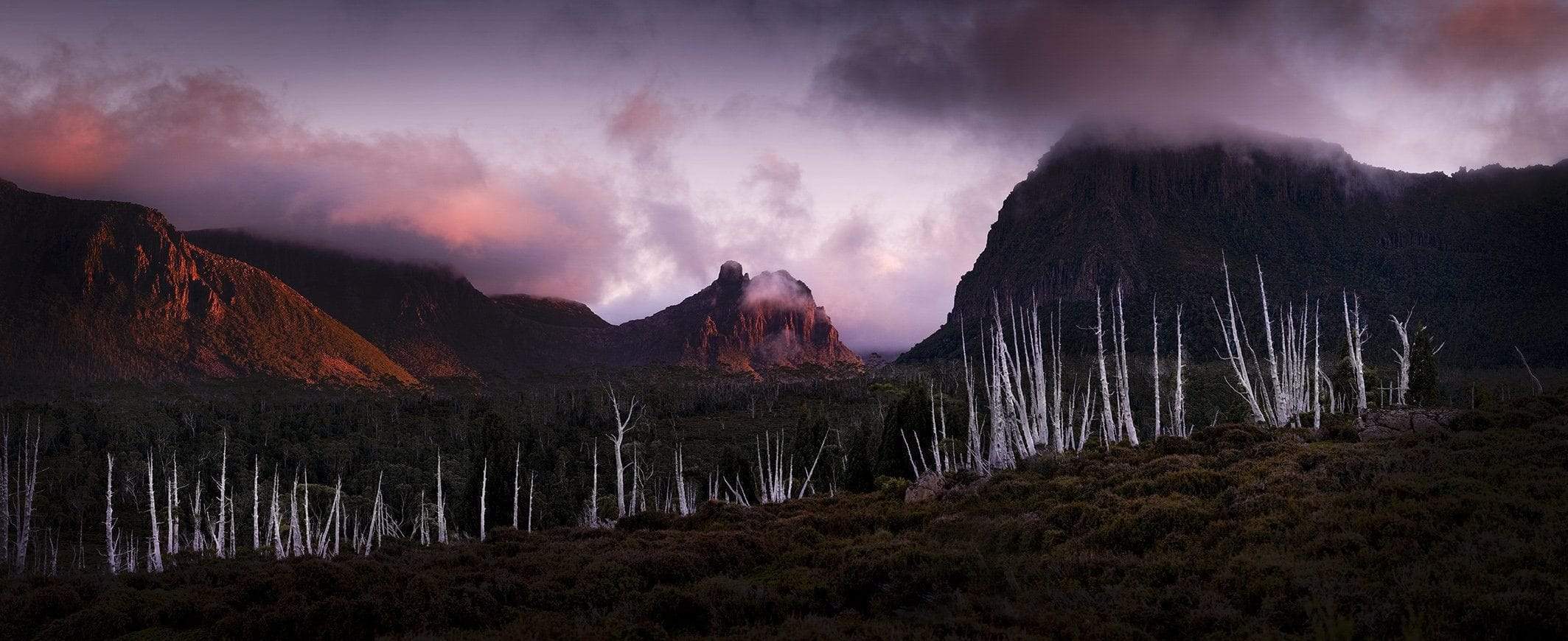Dark vire of giant mountains with smoky effect over, Pelion Gap - Cradle Mountain TAS