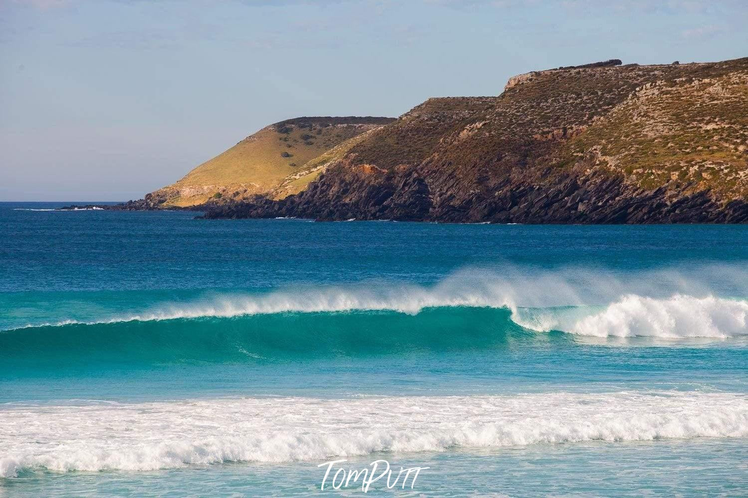 Beautiful bubbling waves in a sea with a huge mountain wall behind, Pennington Bay Surf - Kangaroo Island SA