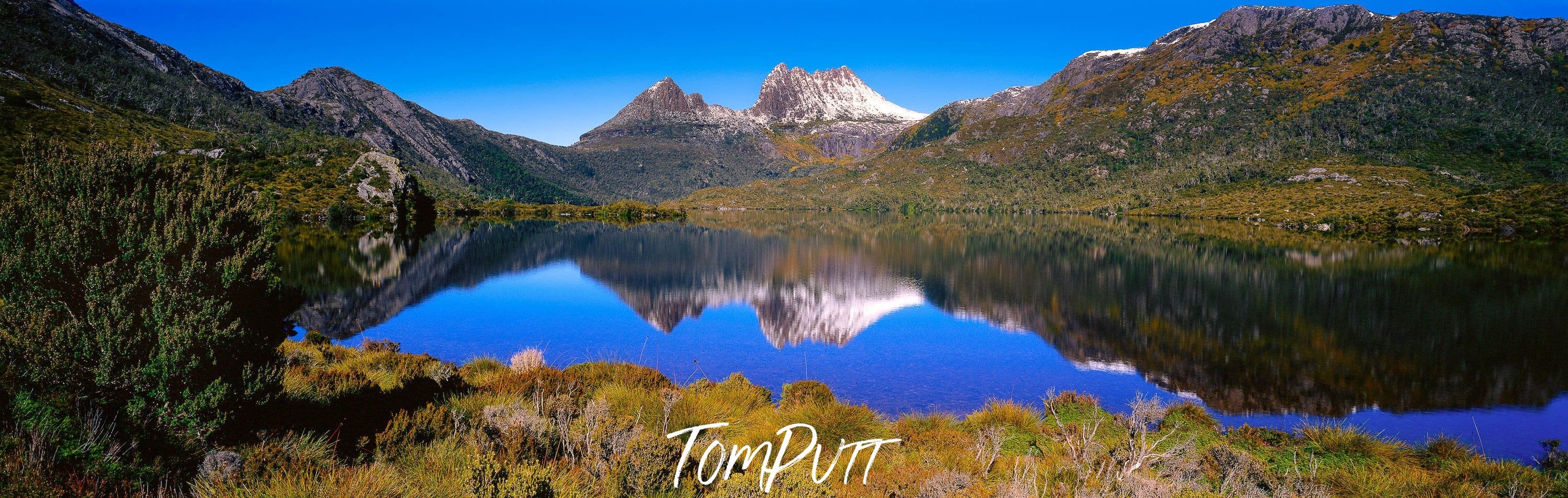 Beautiful mountain walls covered with green grass, and a lake in the center, Perfect Reflection, Cradle Mountain, Tasmania