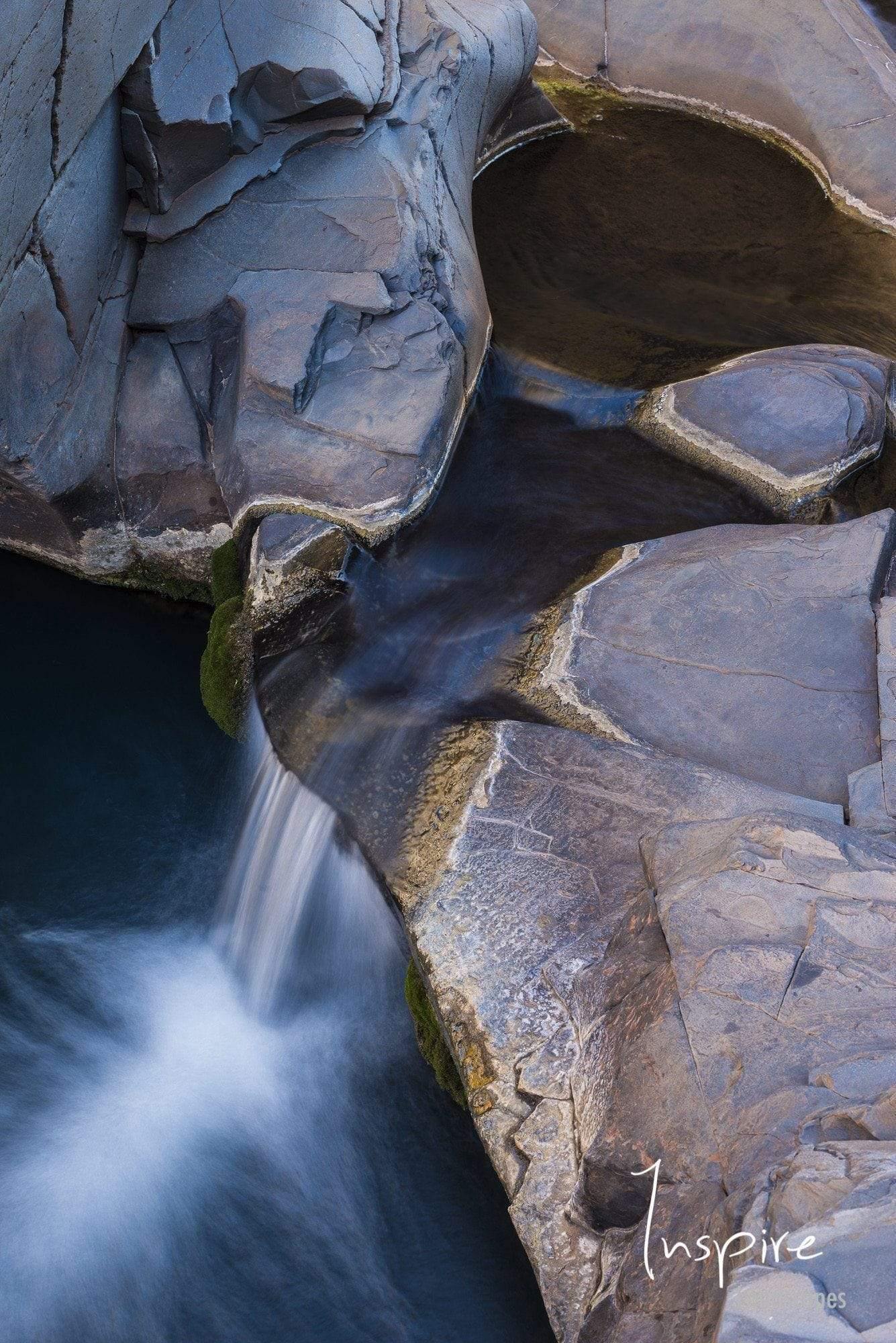 Great rocky stones on a high peak point with a waterfall below, Petit Falls - Karijini, The Pilbara