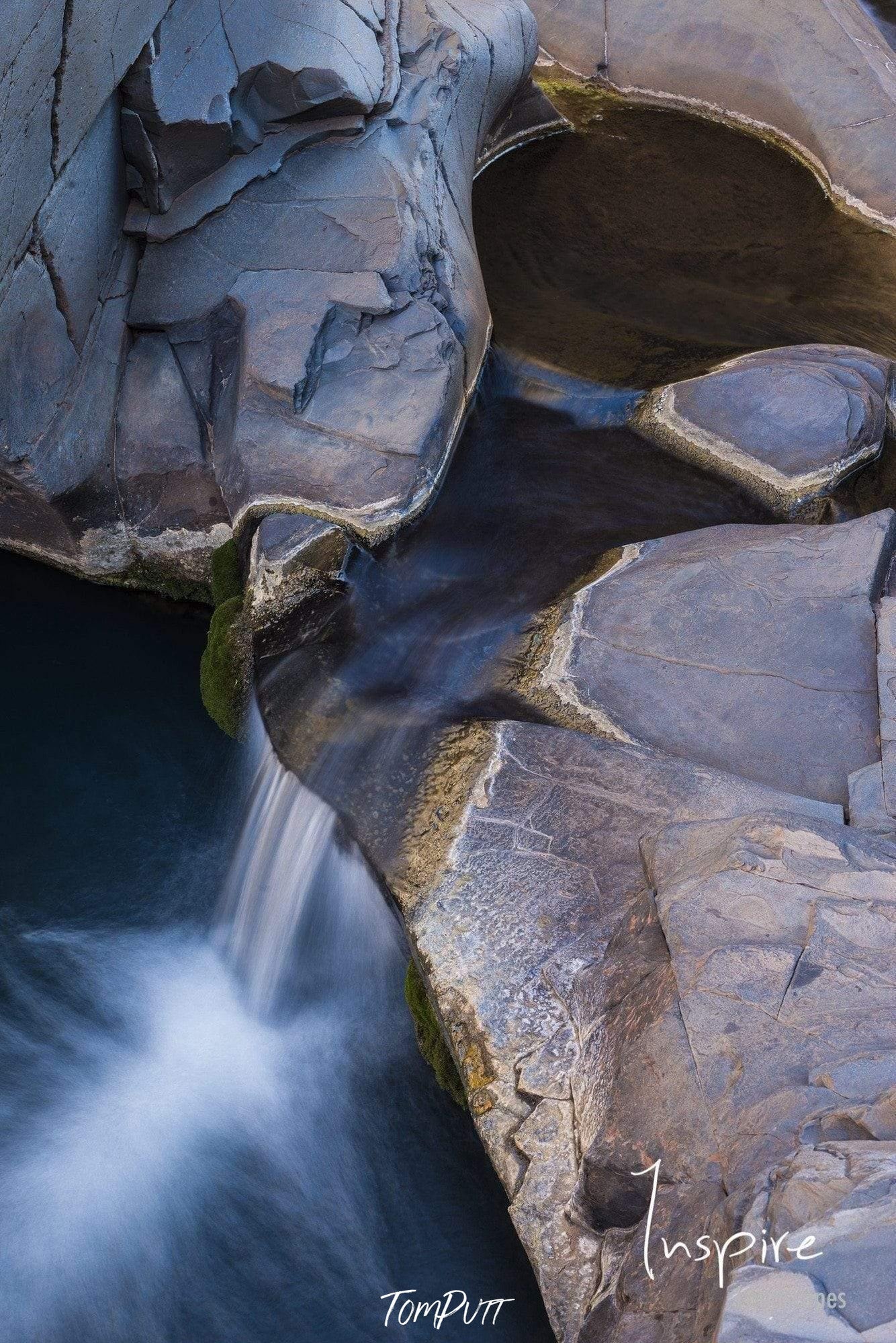 Great rocky stones on a high peak point with a waterfall below, Petit Falls - Karijini, The Pilbara