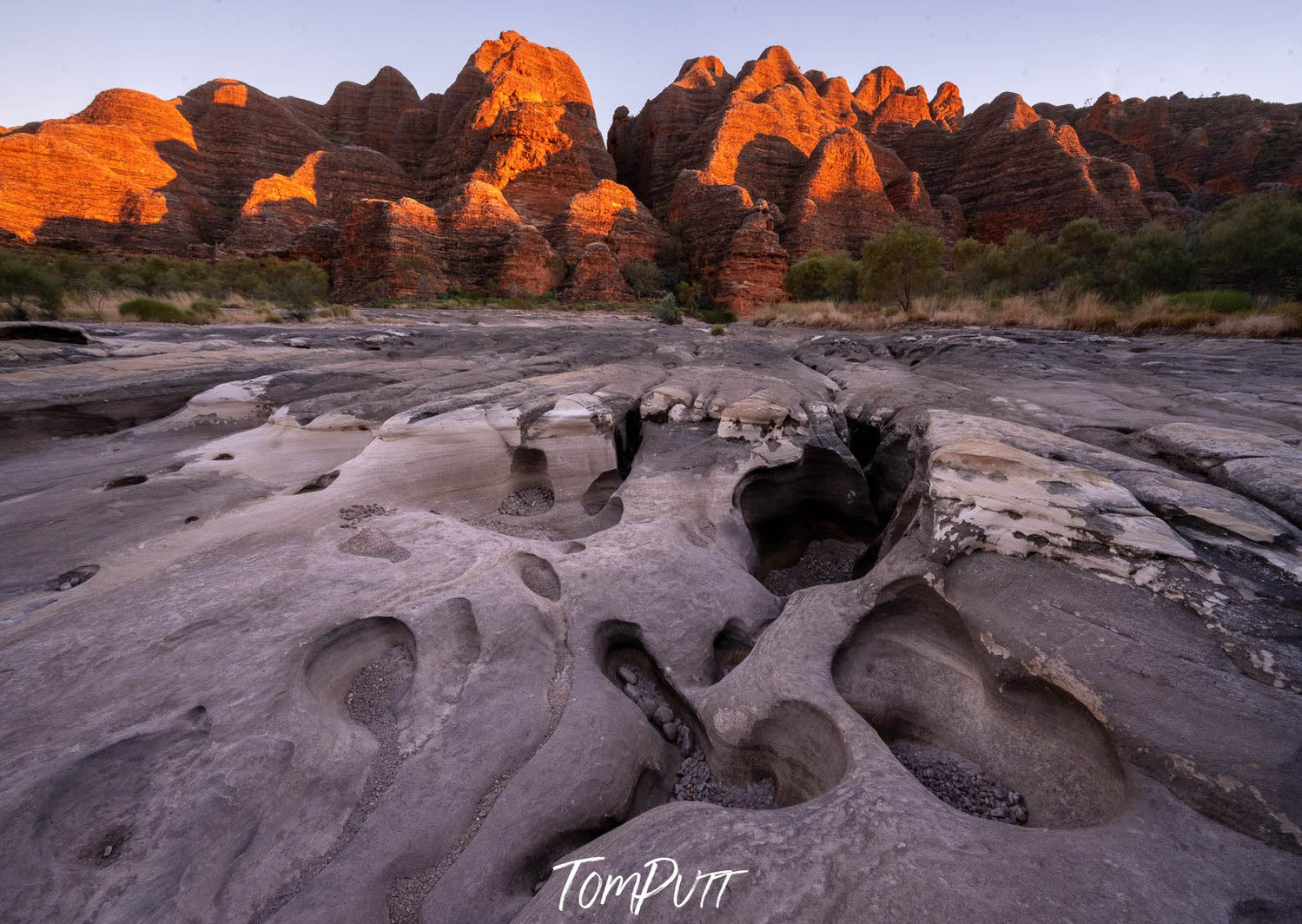 Orangish mountain walls with thick wet sand ahead, Piccaninny Sunrise, Purnululu, The Kimberley, Western Australia