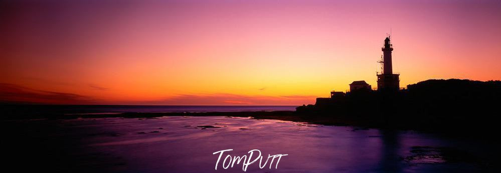 A dark pinkish view of a sea corner and a lighthouse on the mound outside, Point Lonsdale Lighthouse