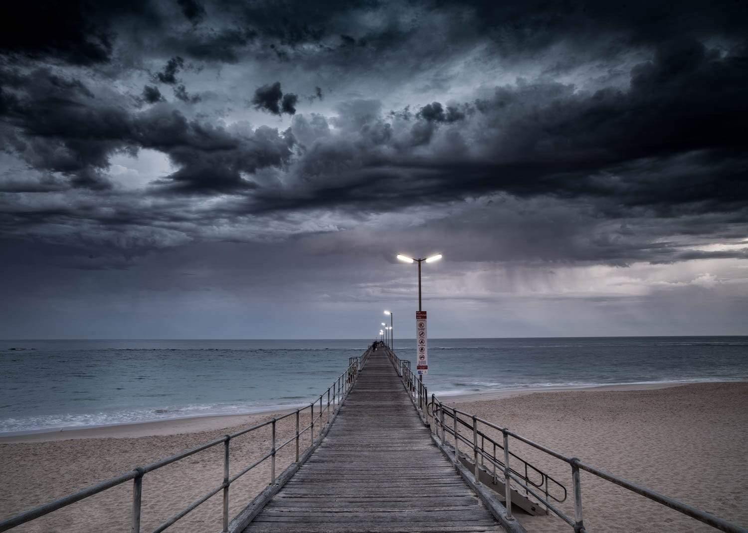 A long wooden track on a beach, and giant black thick clouds in the background, Port Noarlunga Jetty Print