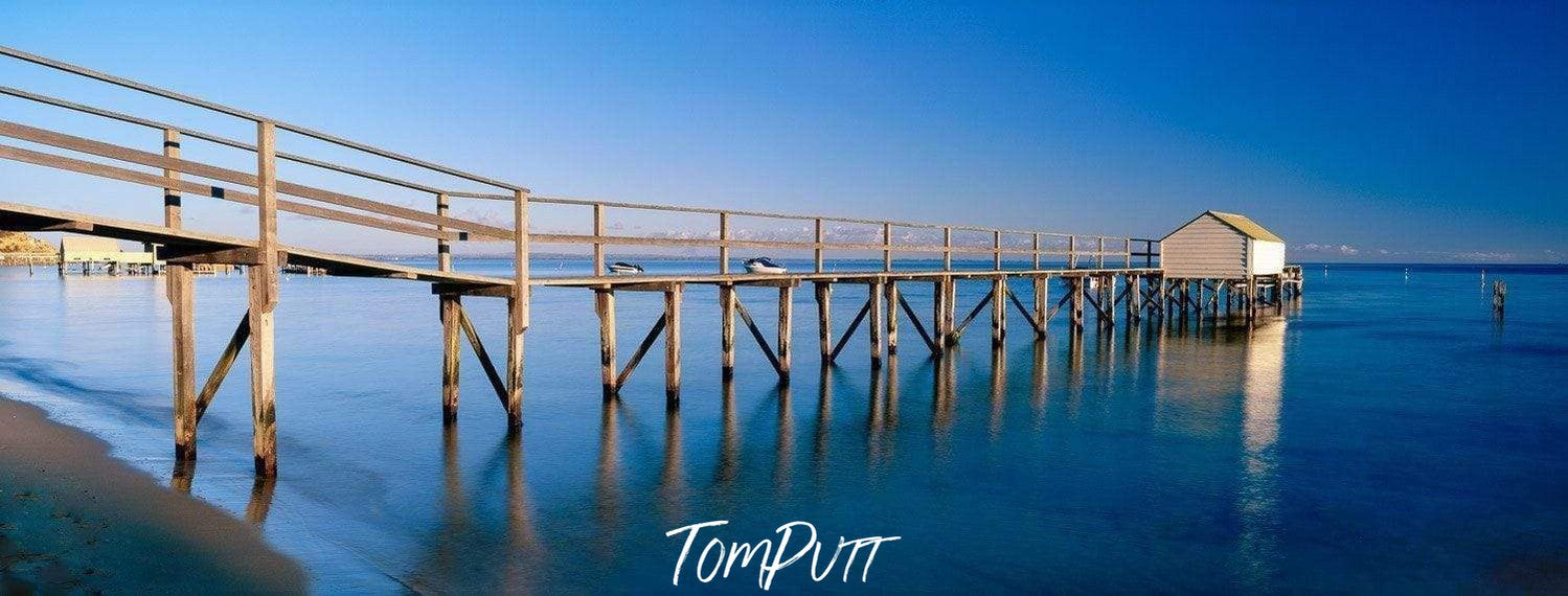 A big wooden bridge over the sea following a small house, Portsea Jetty Mornington Art