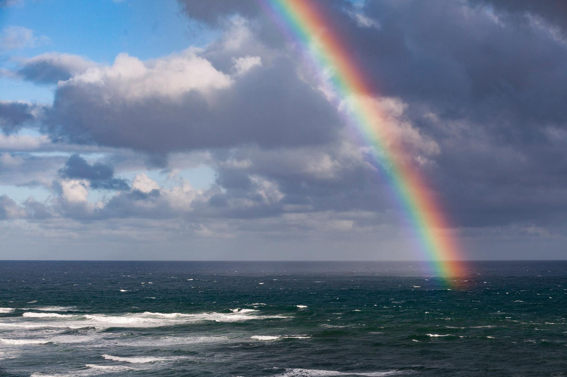 A beautiful rainbow over an ocean with clear white clouds, Pot of Gold - Mornington Peninsula VIC