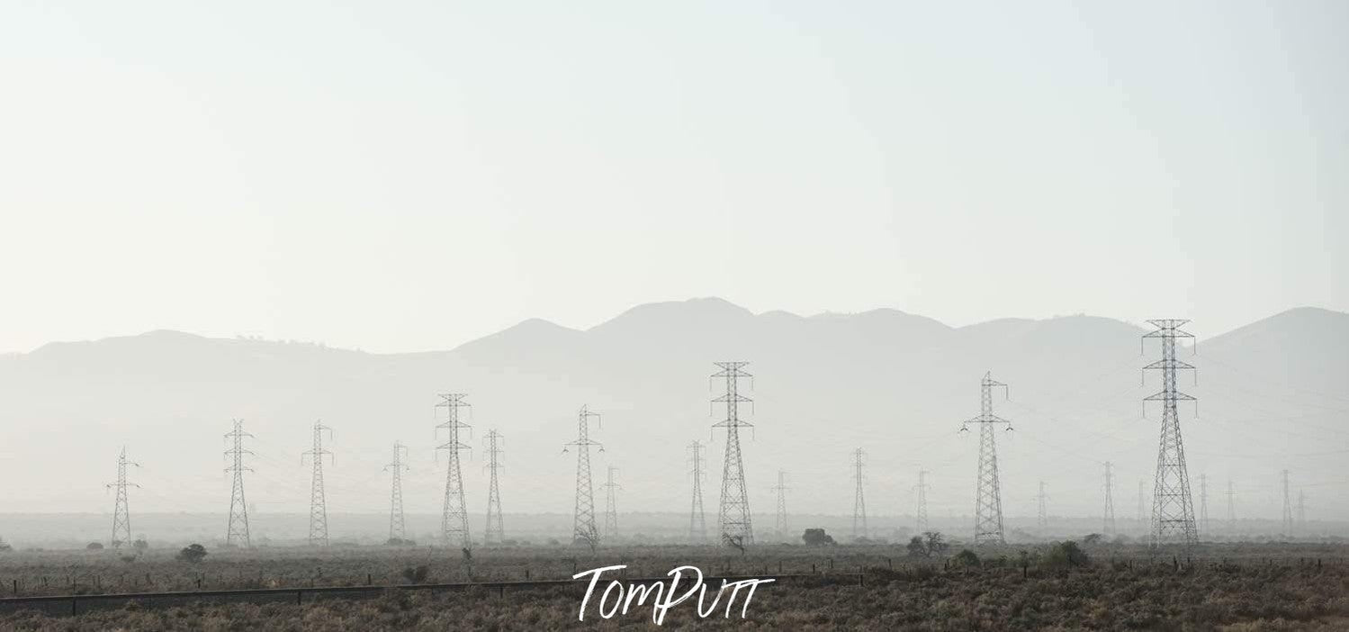 Long shot view of electricity poles with wires on a snow-covered land, Power Poles Port Augusta Art